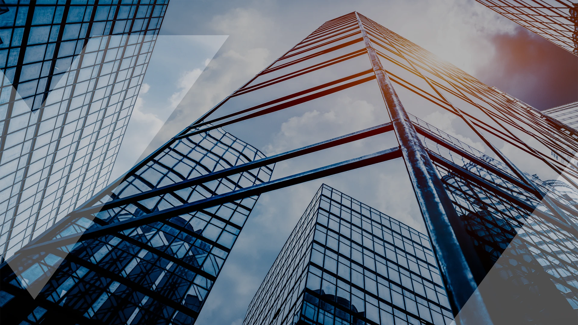 Upward view of modern glass skyscrapers reflecting the sky, symbolizing corporate innovation and advancement