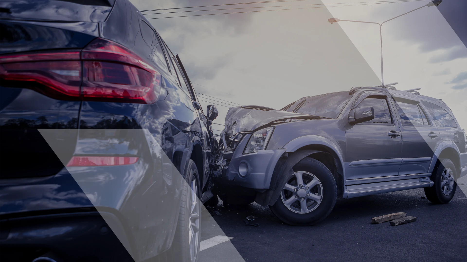 Two SUVs involved in a head-on collision on a road