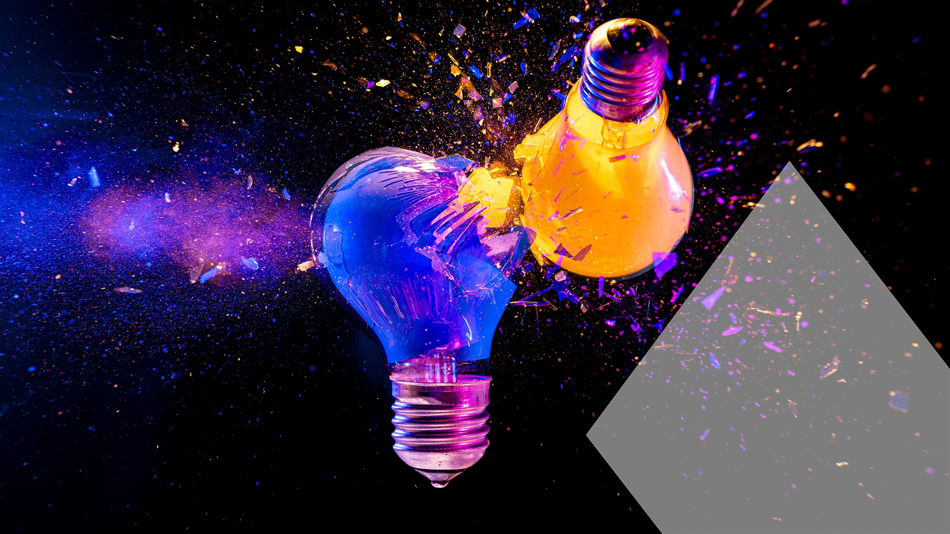 Two colorful light bulbs exploding black background creativity concept
