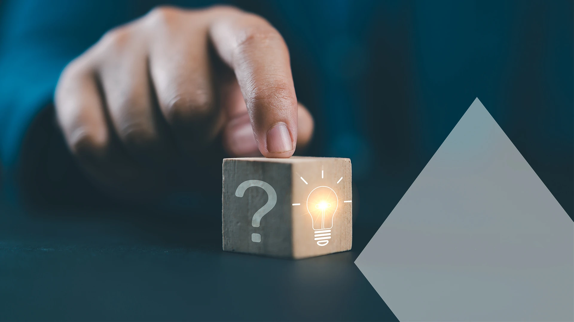 Hand touching Glowing light bulb on bright side and question mark on dark side of wooden block cube for problem solving solution and creative thinking idea innovation concept.